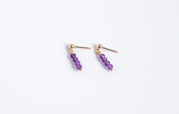 14k gold filled stud earrings with amethyst gemstones from the Moment and Milestone Collection, displayed on a white background.