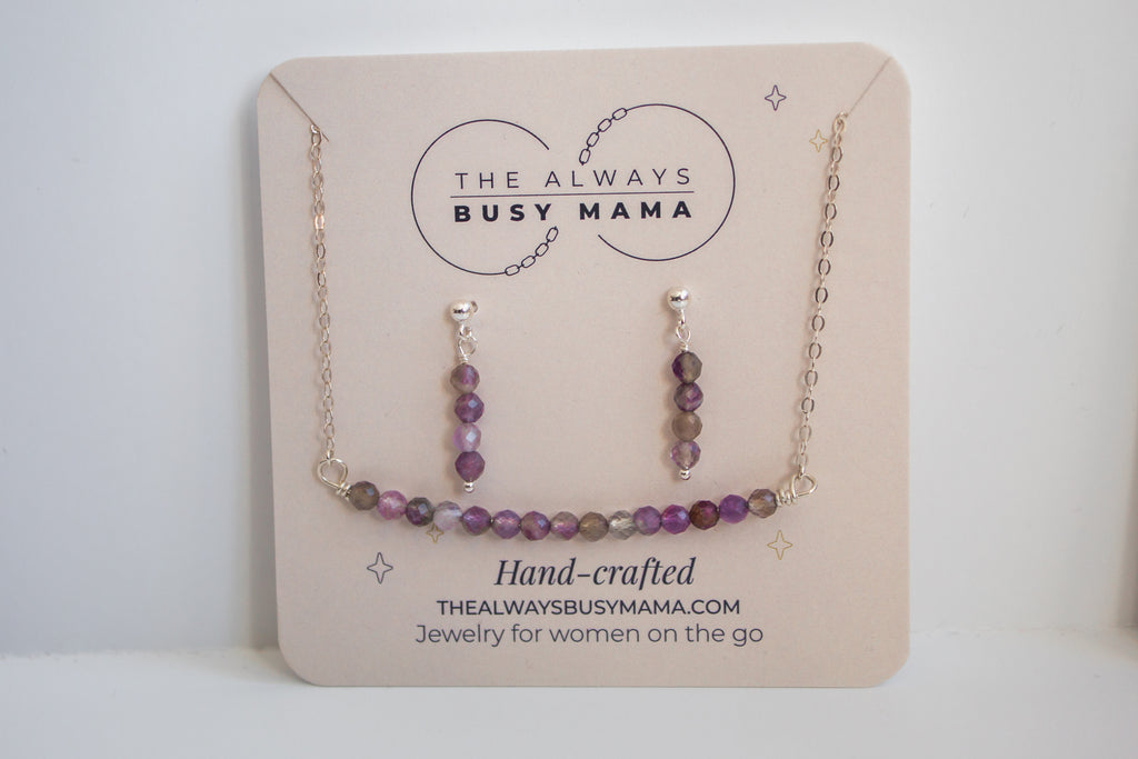 Moments and milestones amethyst stud earring and necklace set on a jewelry card. 