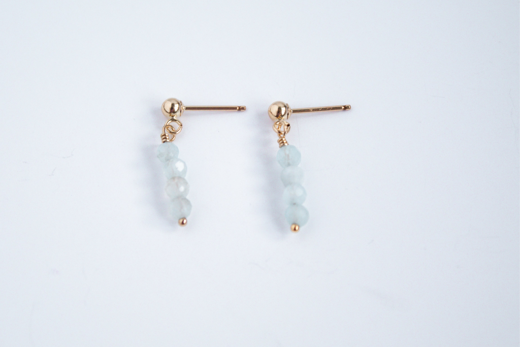 14k gold filled stud earrings with aquamarine gemstones from the Moment and Milestone Collection, displayed on a white background.