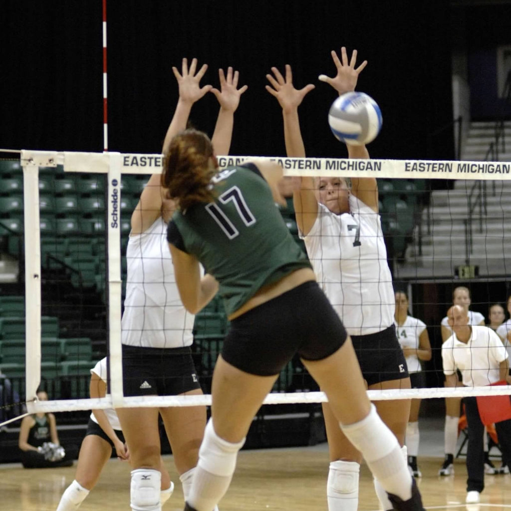 Becky putting up a block with her setter against Michigan State volleyball.