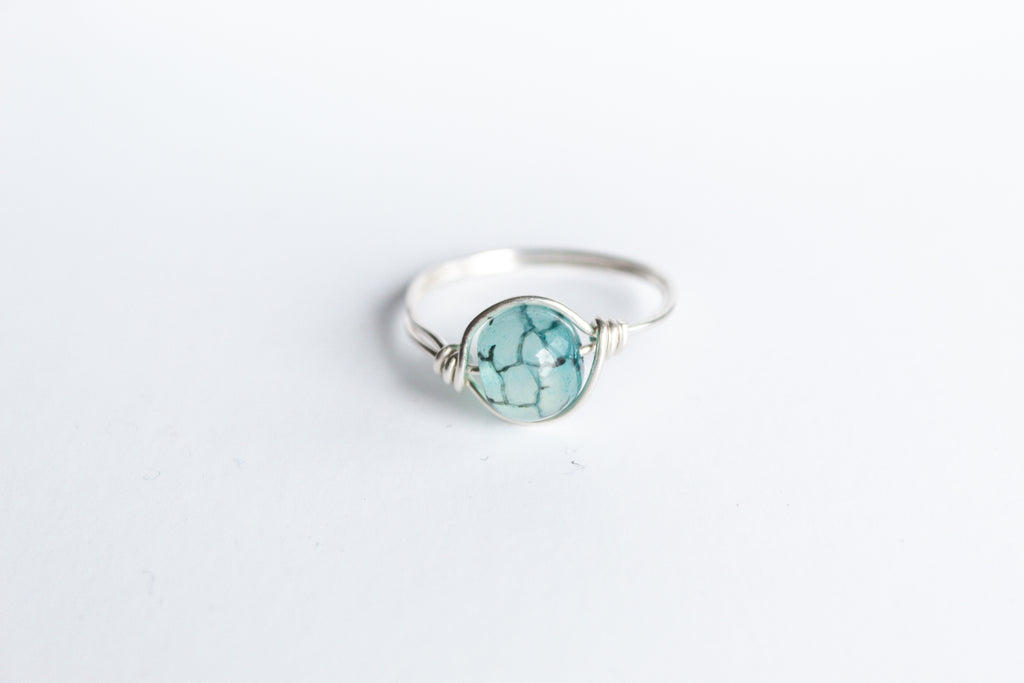 Sterling Silver wire-wrapped ring featuring a blue vein agate gemstone.