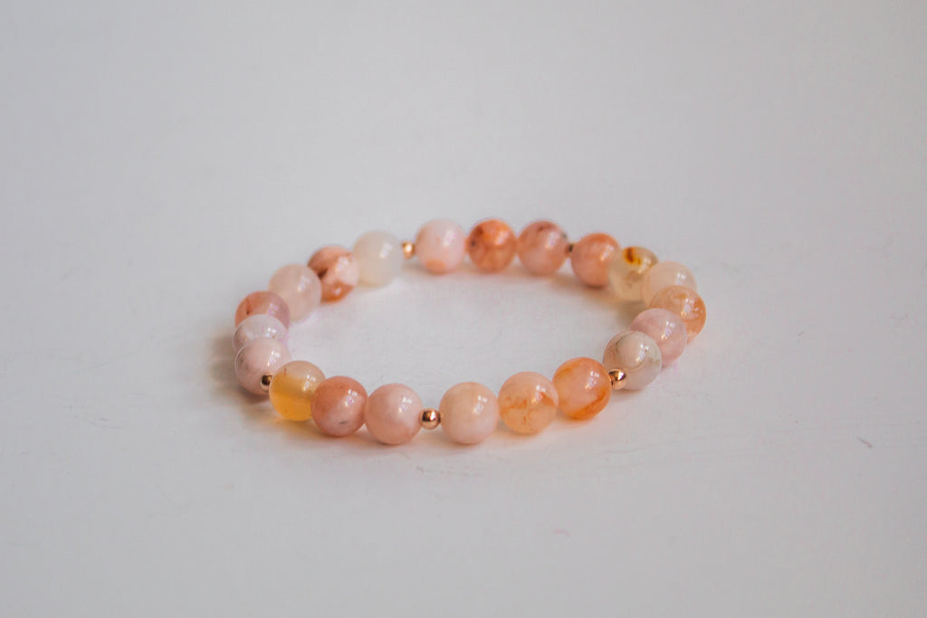 Mama’s Mini Collection stretch bracelet with natural cherry blossom beads and 14k rose gold filled accent beads, displayed on a white background.