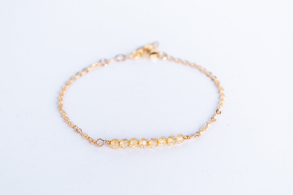 14k gold filled chain bracelet from the Moments and Milestone collection featuring faceted round citrine gemstones.