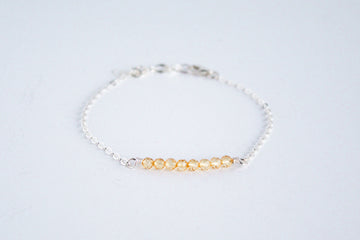 Sterling silver chain bracelet from the Moments and Milestone collection featuring faceted round citrine gemstones.