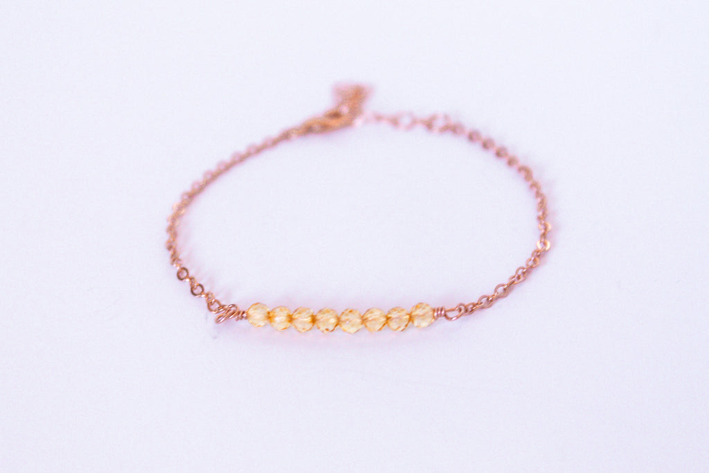 Moments and Milestone chain bracelet with citrine gemstones on a 14k rose gold-filled chain.”