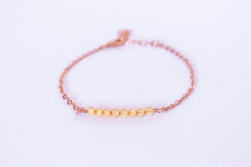 Moments and Milestone chain bracelet with citrine gemstones on a 14k rose gold-filled chain.”