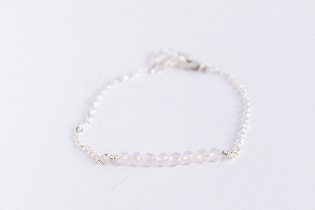 Sterling silver chain bracelet from the Moments and Milestone collection featuring faceted round clear quartz gemstones.