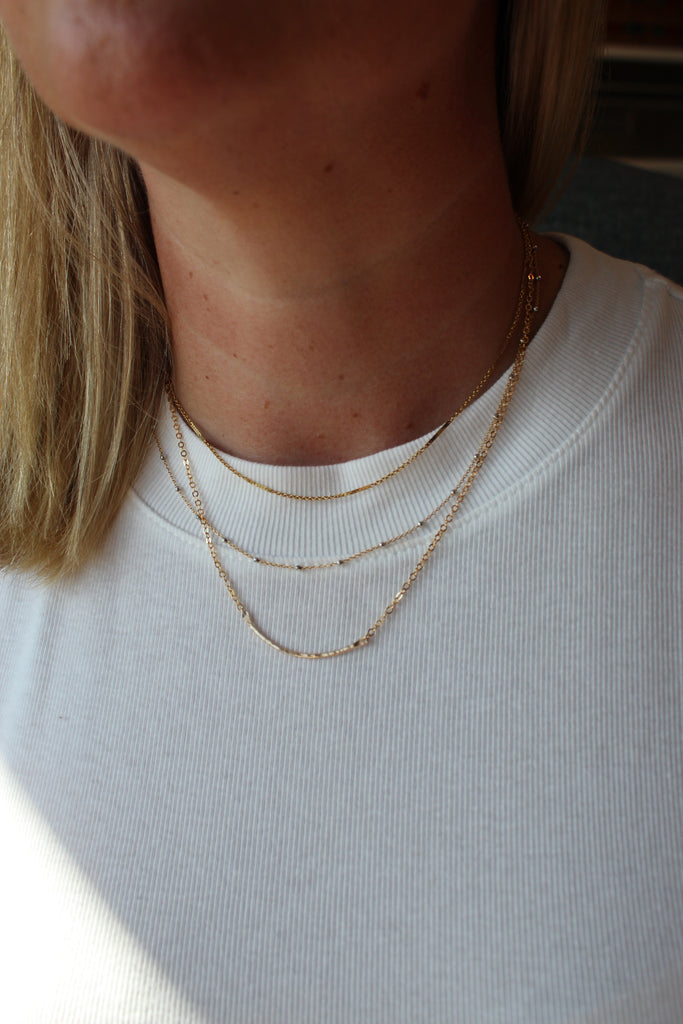 Model wearing gold filled necklaces, perfect for an everyday minimalist look.