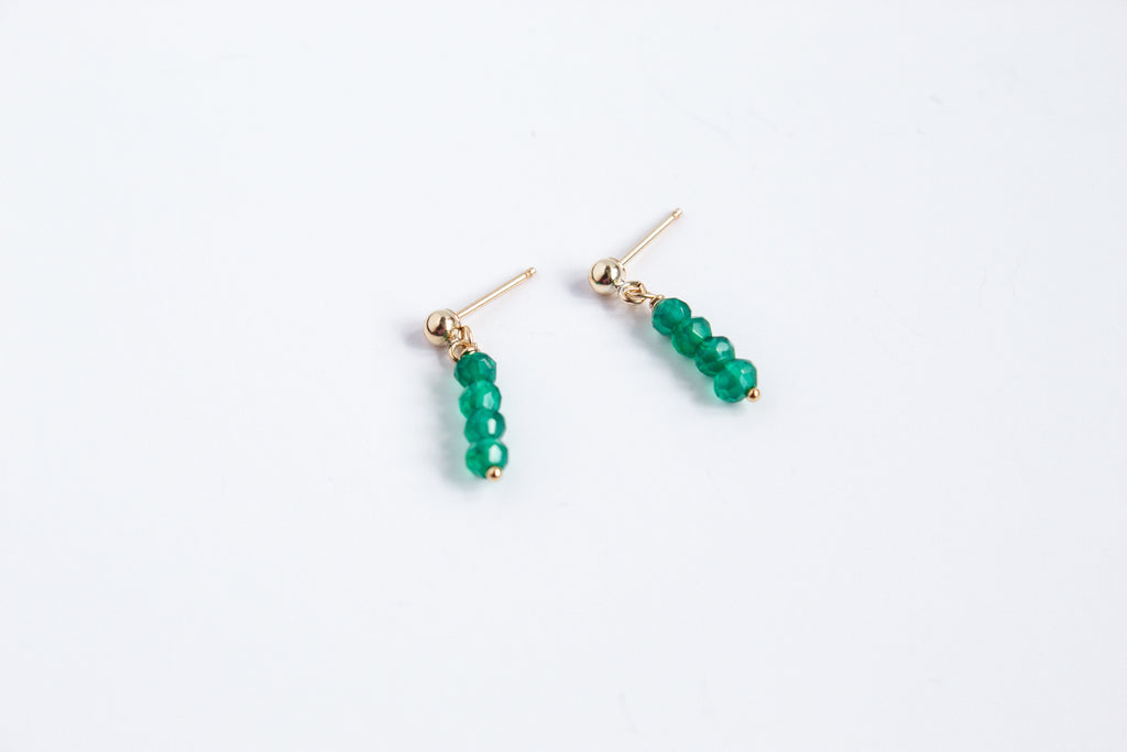 14k gold filled stud earrings with emerald gemstones from the Moment and Milestone Collection, displayed on a white background.