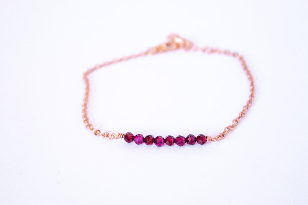 Moments and Milestone chain bracelet with garnet gemstones on a 14k rose gold-filled chain.