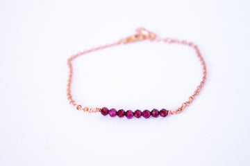 Moments and Milestone chain bracelet with garnet gemstones on a 14k rose gold-filled chain.