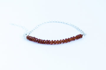 Handcrafted garnet gemstone with sterling silver rolo chain from the Perfect Balance Collection, displayed on a white background.