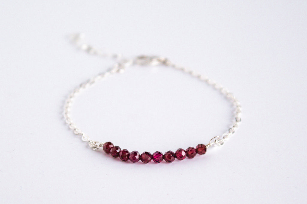 Moments and Milestone chain bracelet with garnet gemstones on a sterling silver chain.