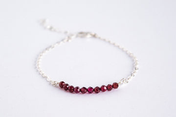 Moments and Milestone chain bracelet with garnet gemstones on a sterling silver chain.