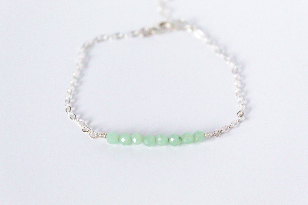 Sterling silver chain bracelet from the Moments and Milestone collection featuring faceted round jade gemstones.