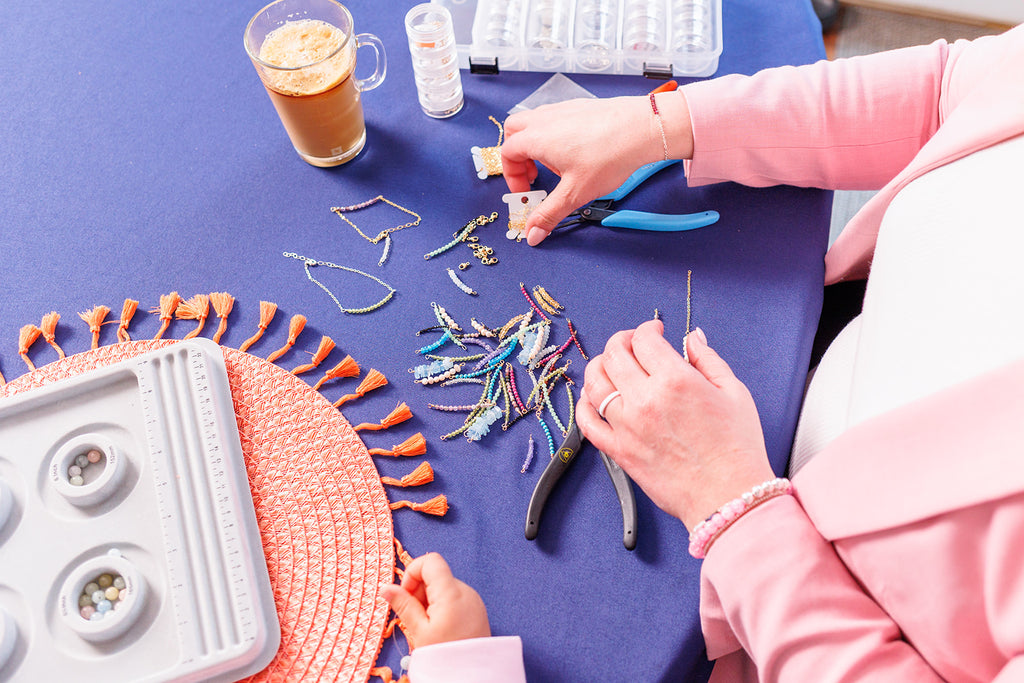 Becky making gemstone jewelry at her kitchen table.