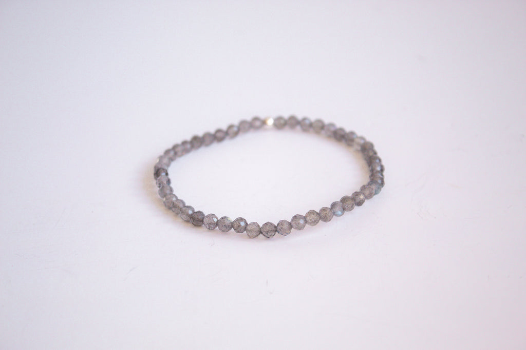 Labradorite gemstone stretch bracelet from the mama's stretch bracelet collection, with one sterling silver bead, presented on a pure white background.