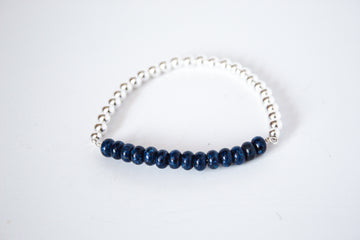 Handcrafted lapis lazuli gemstone and sterling silver stretch bracelet from the Perfect Balance Collection, displayed on a white background.