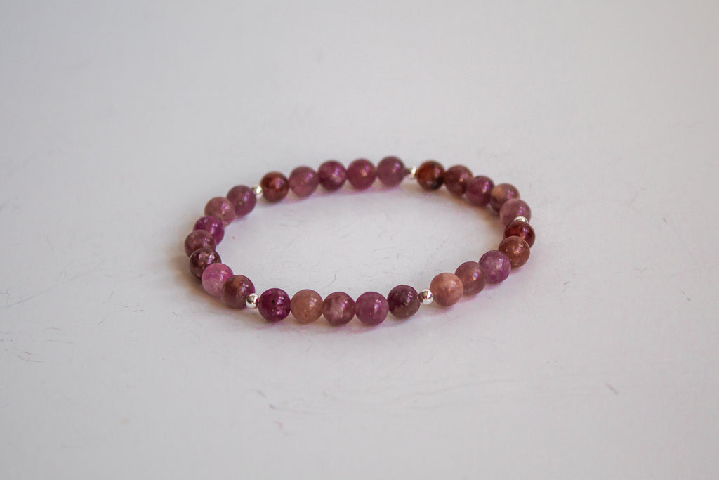 AAA Lepidolite gemstone bracelet with sterling silver accent beads from the Mama’s Mini Collection, laid flat against a white background.