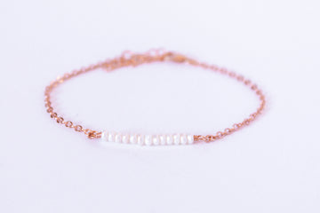 Moments and Milestone chain bracelet with 2mm pearls on a 14k rose gold-filled chain.”