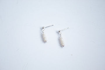 Sterling silver stud earrings with mini pearls from the Moment and Milestone Collection, displayed on a white background.