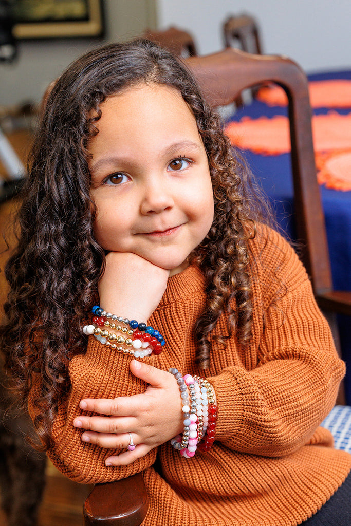 Olivia, the owners daughter, wearing a stack of mama’s mini bracelets. 