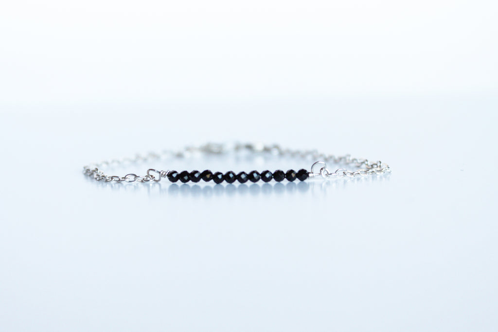 Sterling silver bracelet from the Moments and Milestone collection featuring faceted round onyx gemstones.