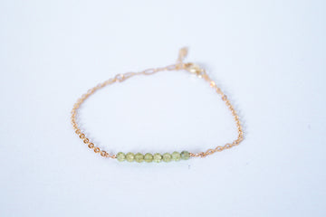 14k gold filled chain bracelet from the Moments and Milestone collection featuring faceted round peridot gemstones.