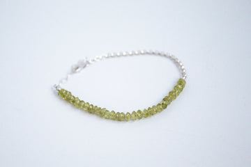 Peridot stone with sterling silver chain, part of the perfect balance collection on a white background  