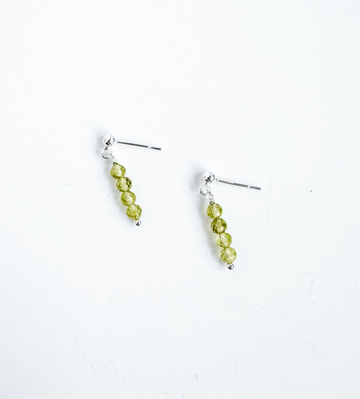 Sterling silver stud earrings with peridot gemstones from the Moment and Milestone Collection, displayed on a white background.