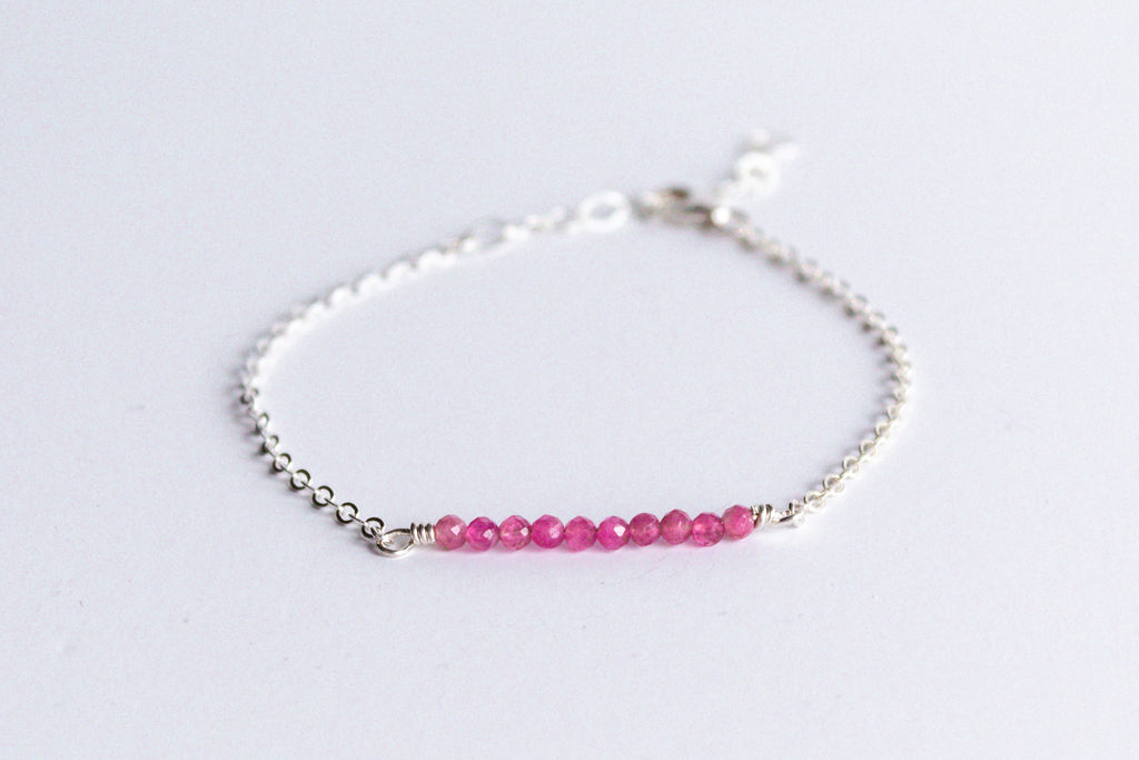 Sterling silver chain bracelet from the Moments and Milestone collection featuring faceted round pink tourmalines gemstones.