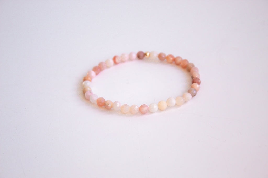 Pink Opal gemstone stretch bracelet from the mama's stretch bracelet collection, with one 14k gold filled bead, presented on a pure white background.