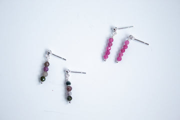 Moment and Milestone stud earrings in sterling silver and dangling mixed tourmaline and pink tourmaline gemstones, symbolizing life’s meaningful moments, displayed on a white background.