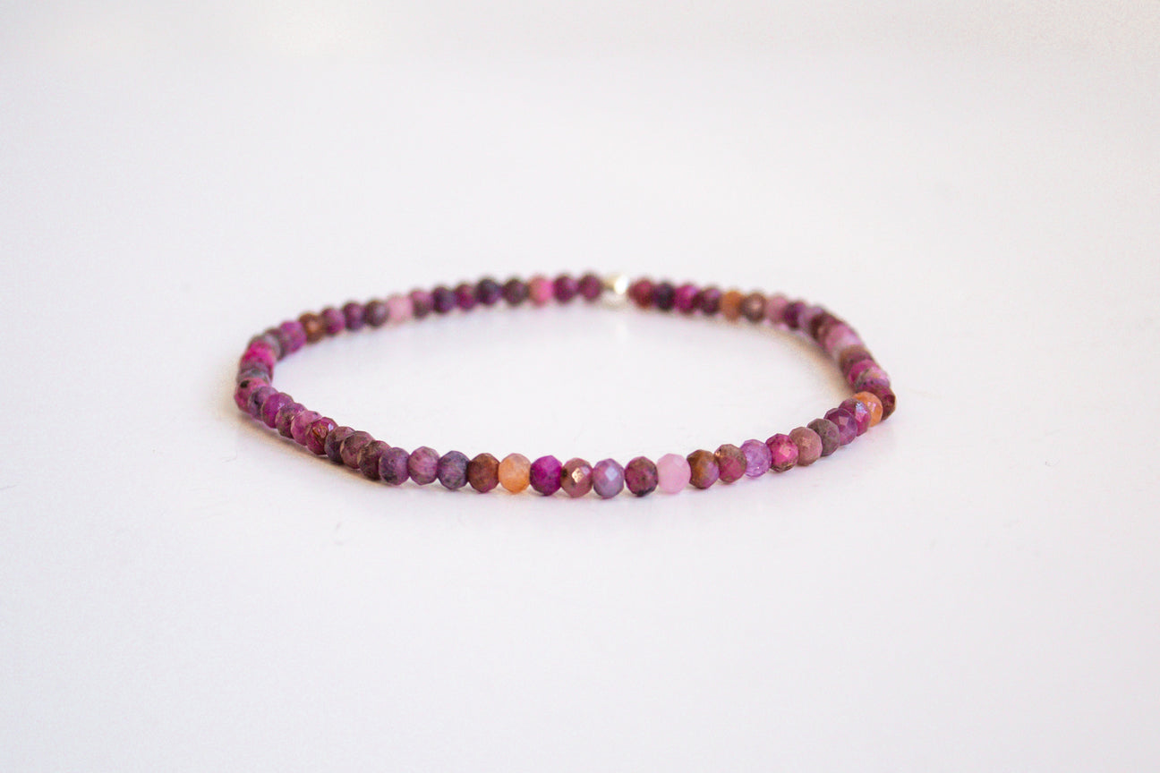 pink and purple tourmaline round cut gemstone stretch bracelet from the mama's stretch bracelet collection, with one 14k gold filled bead, presented on a pure white background.