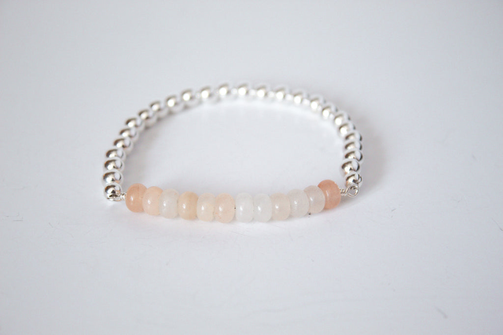 Pink aventurine stone with sterling silver beads, part of the perfect stretch bracelet on a white background  