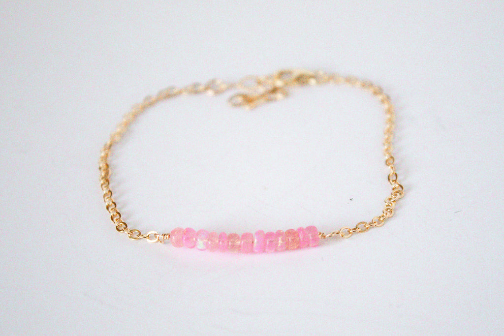 14k gold filled chain bracelet from the Moments and Milestone collection featuring faceted round pink Ethiopian opal gemstones.