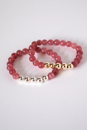 Pink tourmaline gemstone stretch bracelet handmade in Cheshire, CT in sterling silver and 14k gold filled on a white background. 