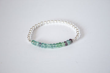 Rainbow Fluorite stone with sterling silver beads, part of the perfect stretch bracelet on a white background  