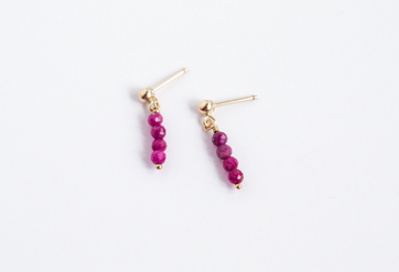 14k gold filled stud earrings with ruby gemstones from the Moment and Milestone Collection, displayed on a white background.