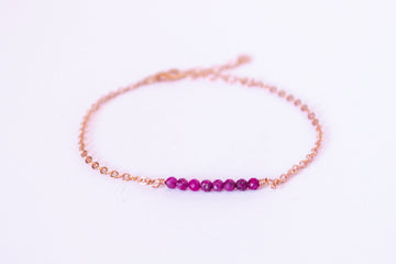 Moments and Milestone chain bracelet with ruby gemstones on a 14k rose gold-filled chain.