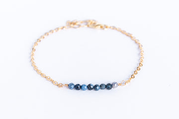 14k gold filled bracelet from the Moments and Milestone collection featuring a faceted sapphire gemstones.