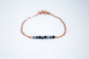 14k rose gold filled chain bracelet from the Moments and Milestone collection featuring faceted round sapphire gemstones.