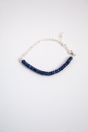 Perfect Balance sterling silver chain bracelet with sapphire gemstone on a white background.