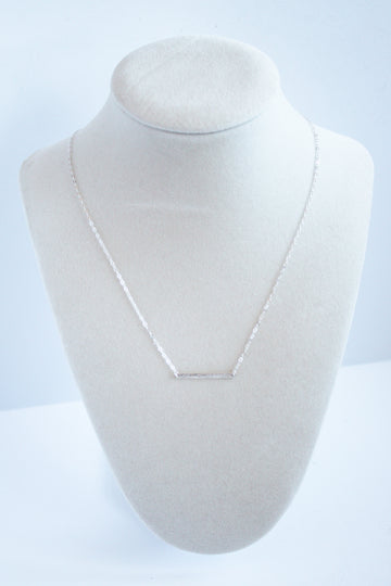 Sterling silver hammered bar necklace, showcasing a textured and elegant gold bar pendant, displayed on a clean white background.”