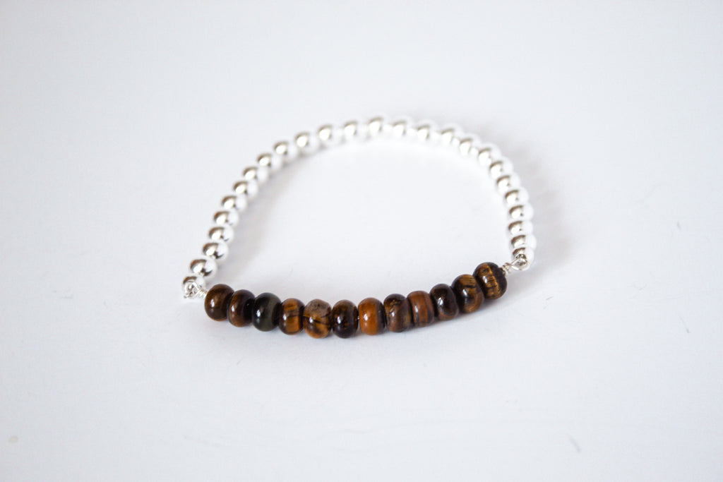 Tiger eye stone with sterling silver beads, part of the perfect stretch bracelet on a white background  