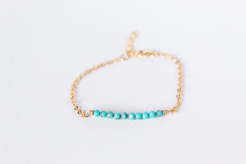 14k gold filled chain bracelet from the Moments and Milestone collection featuring faceted round turquoise gemstones.