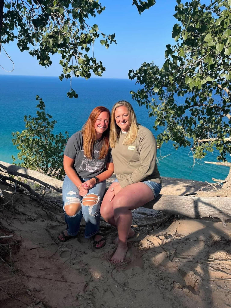 Becky and her twin sister, Abby sitting near Lake Michigan where she is originally from.