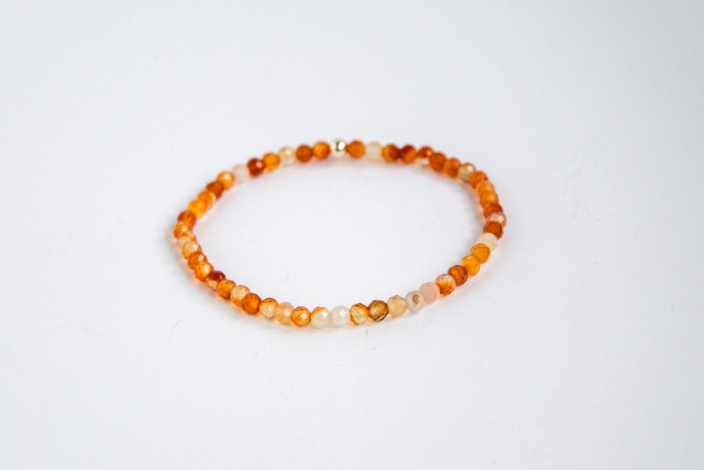 Handcrafted stretch bracelet with carnelian gemstones, photographed on a white background