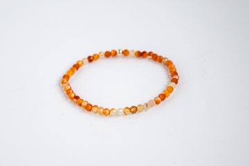 Handcrafted stretch bracelet with carnelian gemstones, photographed on a white background