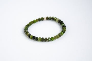 Fall collection gemstone stretch bracelet featuring green nephrite jade beads, worn on a wrist for an autumn-inspired look.